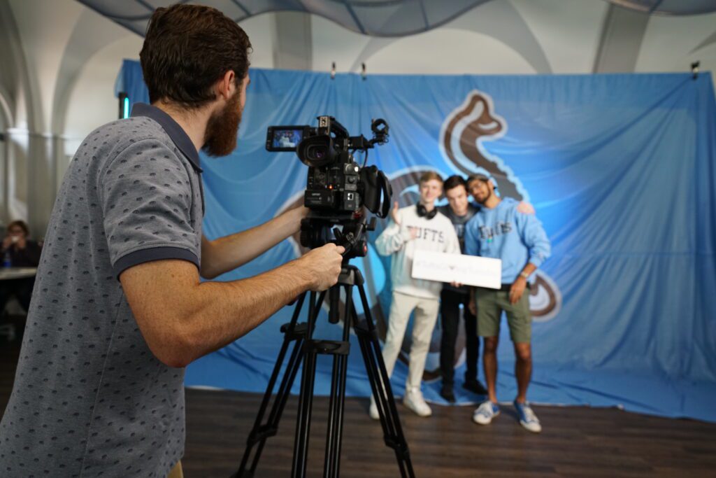 Connor Clougherty filming the Tufts Gaming HUB on a giant Jumbo background