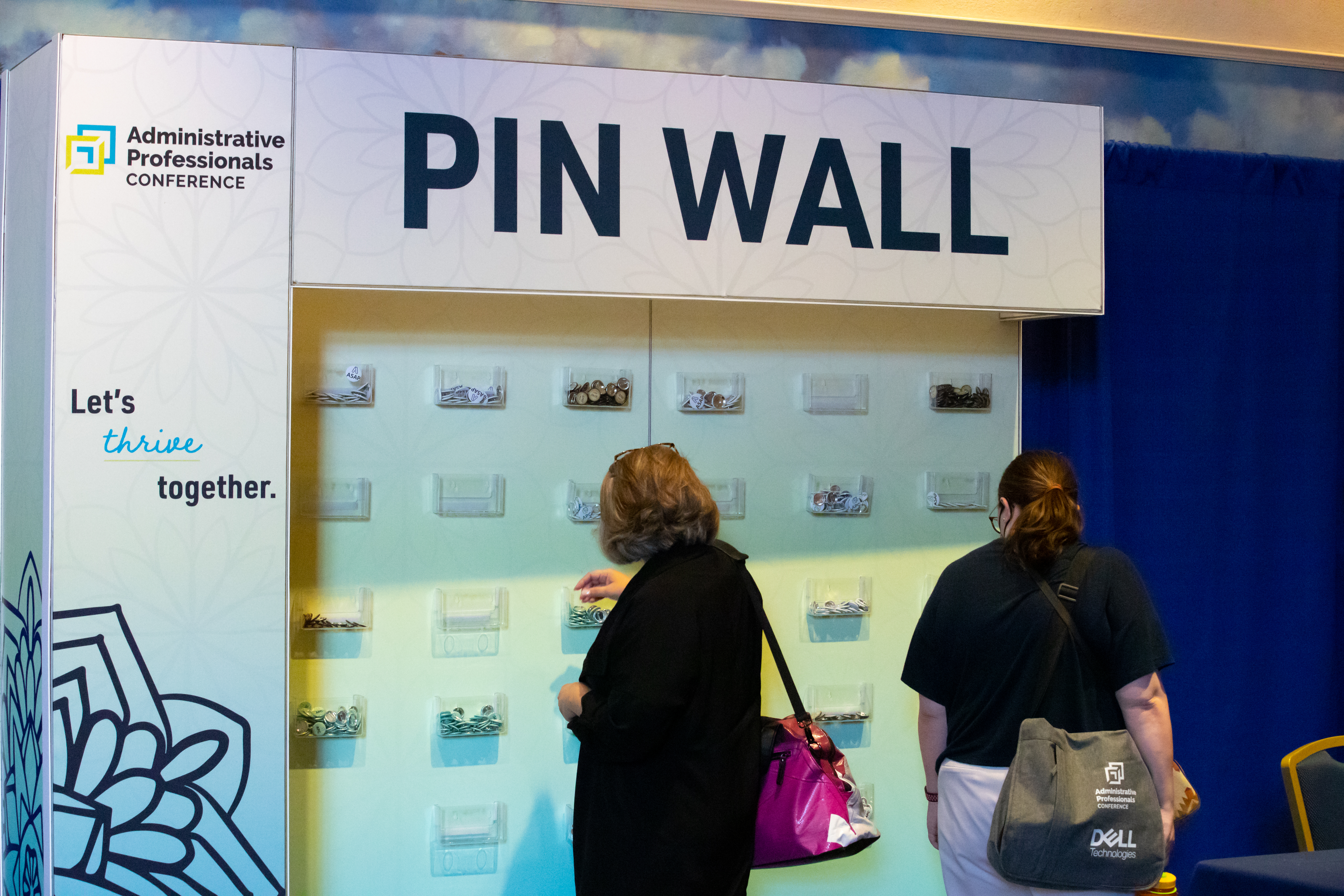 Event attendees at a pin wall