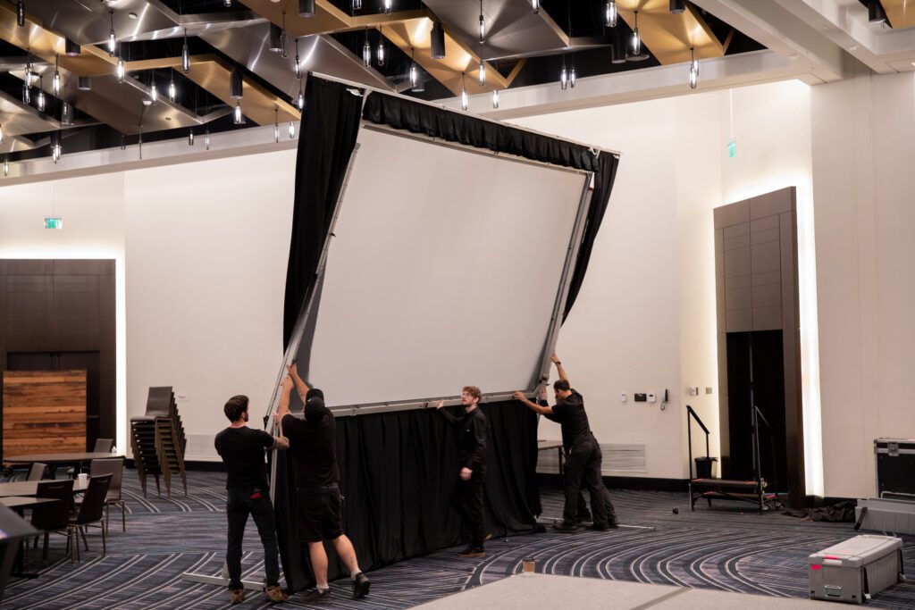 Projection screens being put up