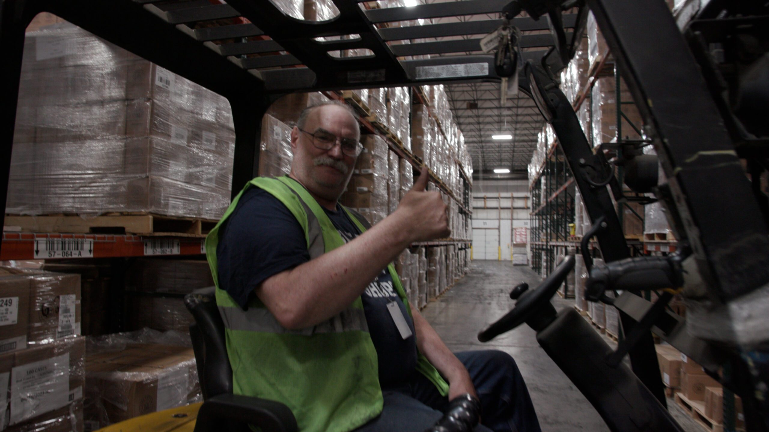 Employee on forklift giving thumbs up