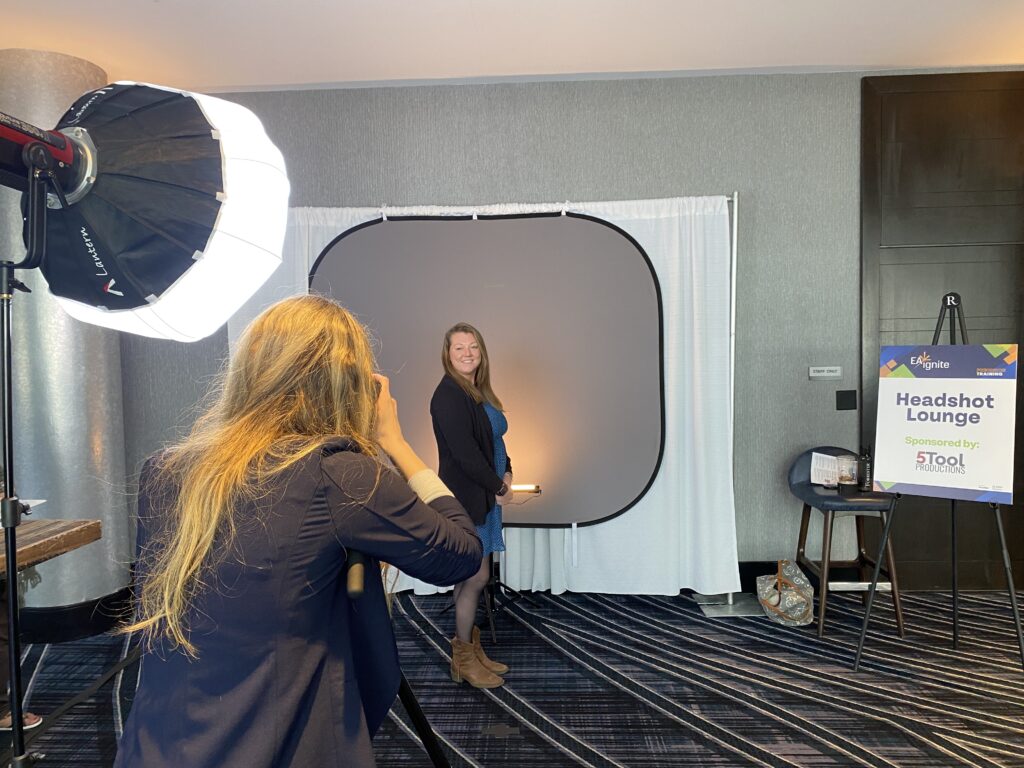 Woman taking photo at a headshot booth at an event