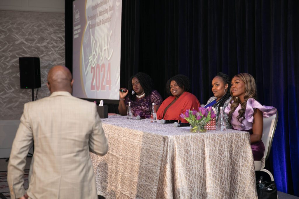 Man asking question to panel at event