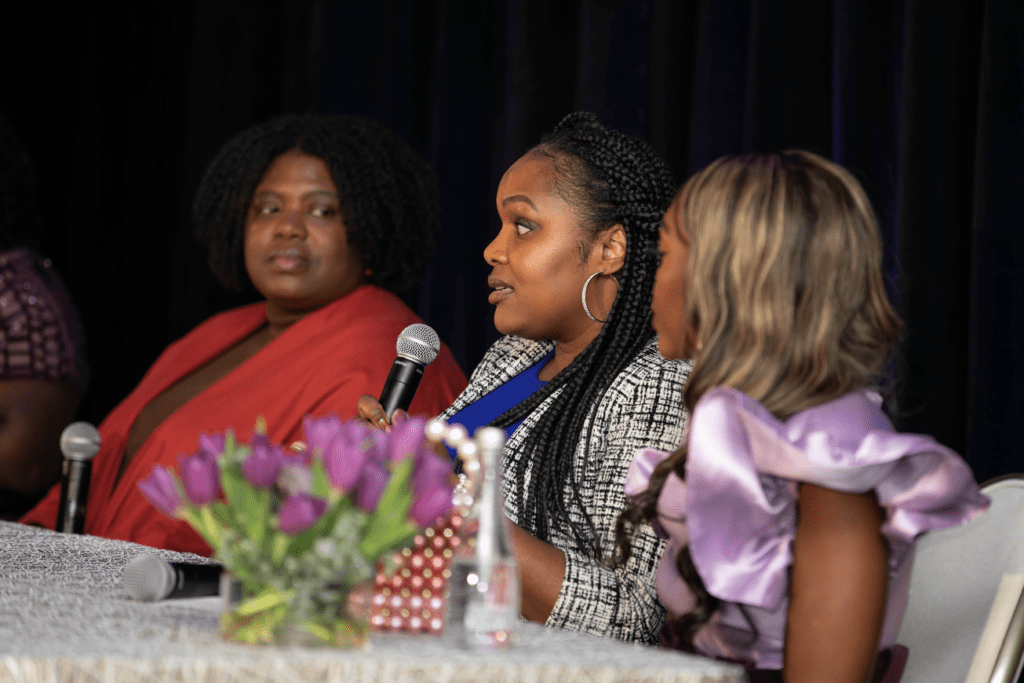 Woman speaking on panel at event