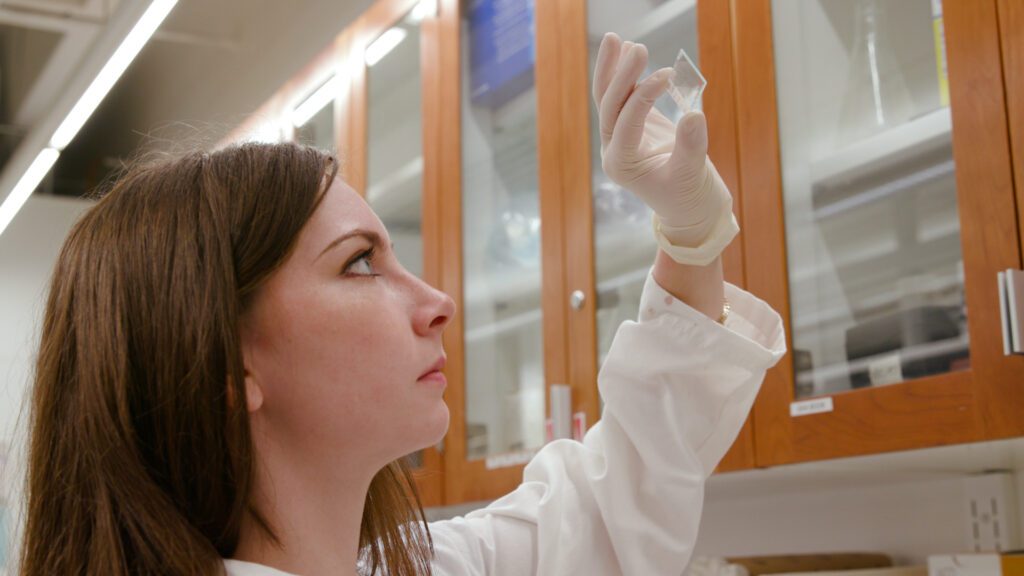 Woman scientist looking at a slide