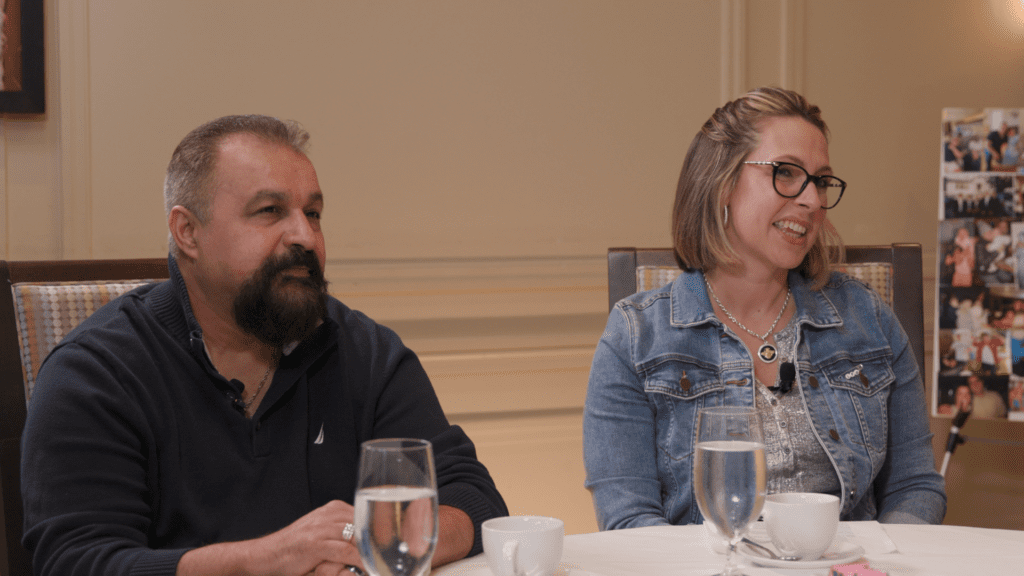 Two people sitting down reacting at a round table discussion