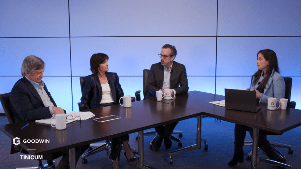 Four people sitting at a table having a discussion