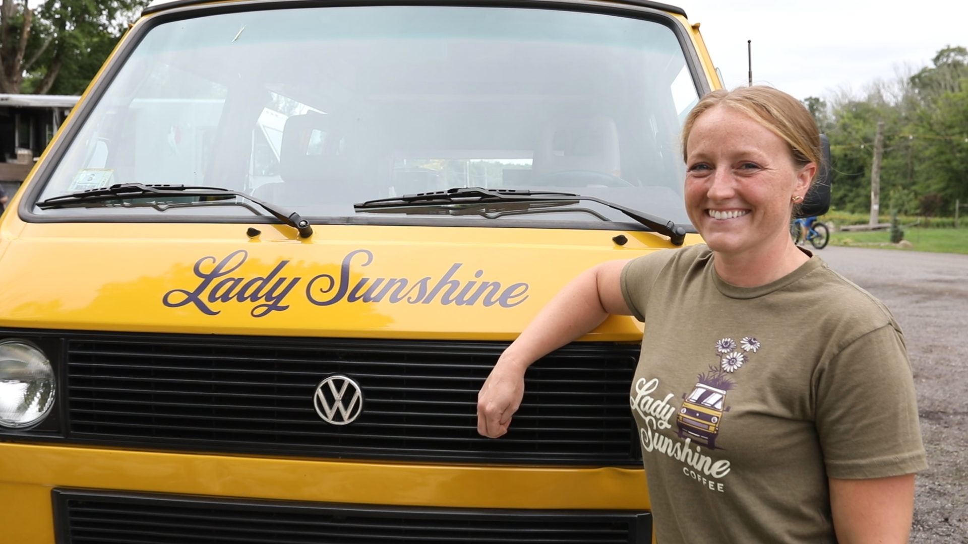 Woman standing next to a truck that says "Lady Sunshine"