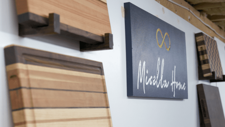 Wall of cutting boards and a business sign that reads "Micella Home"