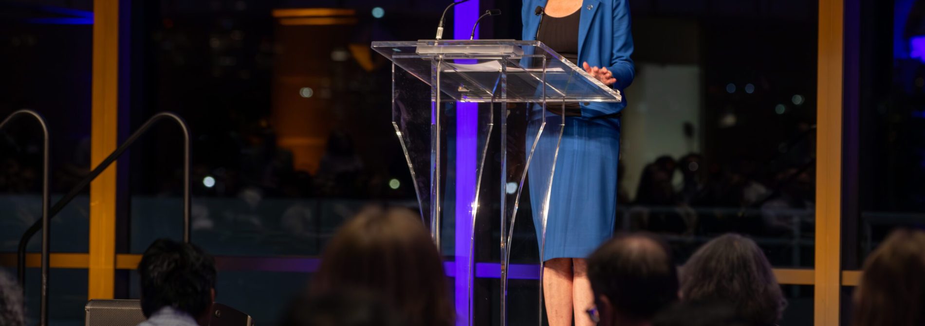 A woman at a podium delivering a speech.