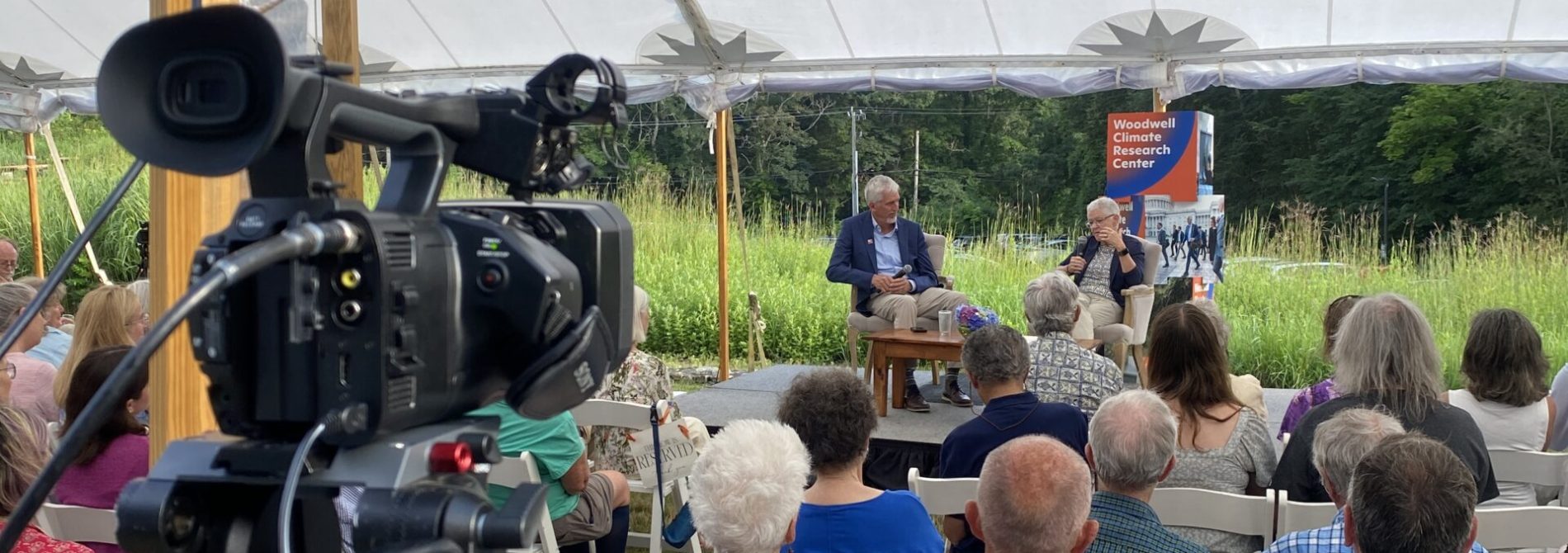 Wide shot behind camera pointed at stage